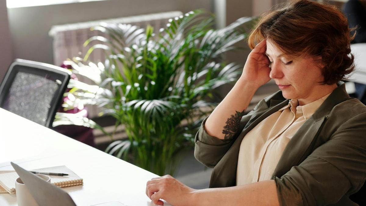 Mujer con dificultad para concentrarse en el trabajo