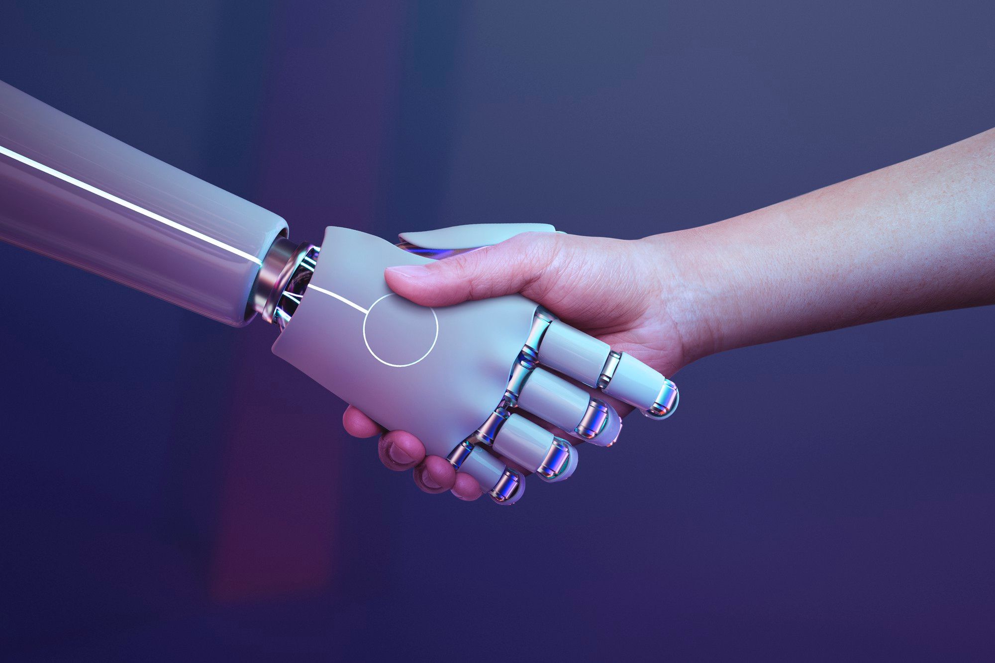 Apretón de manos entre un brazo humano y un robot.