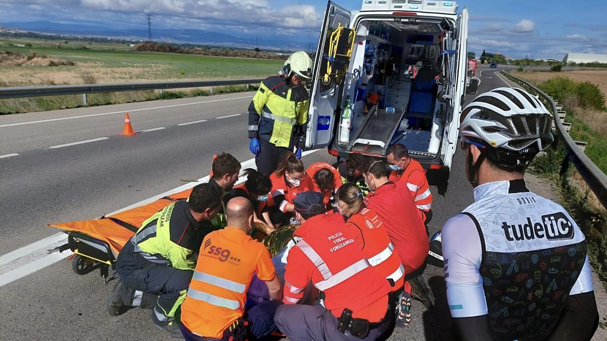 Personal sanitario, bomberos y policías forales atienden al herido más grave.