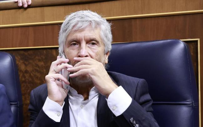 Fernando Grande-Marlaska habla por teléfono durante el pleno del Congreso de este 3 de septiembre.