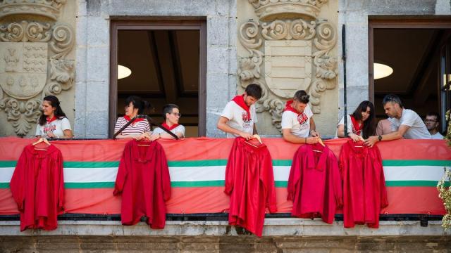 Integrantes de Axeri dantza colocan sus casacas en el ayuntamiento.
