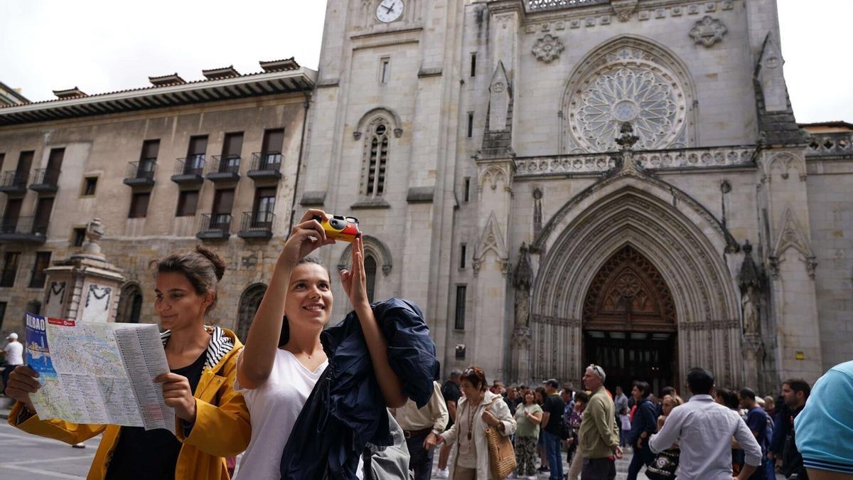 Turistas de vacaciones haciendo fotos en el casco viejo bilbaíno