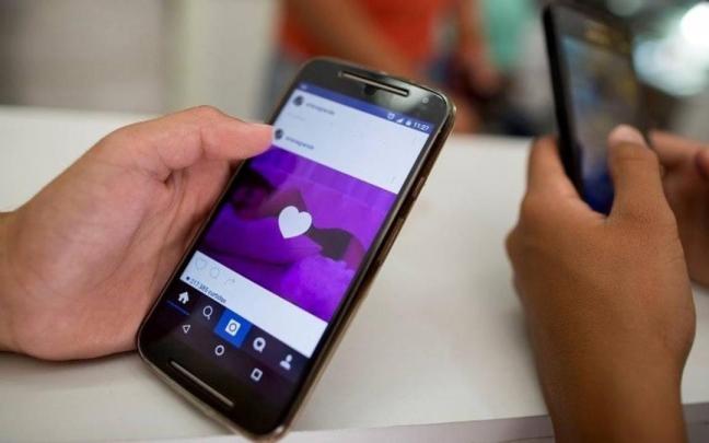 Un grupo de menores de edad hace uso de las redes sociales.