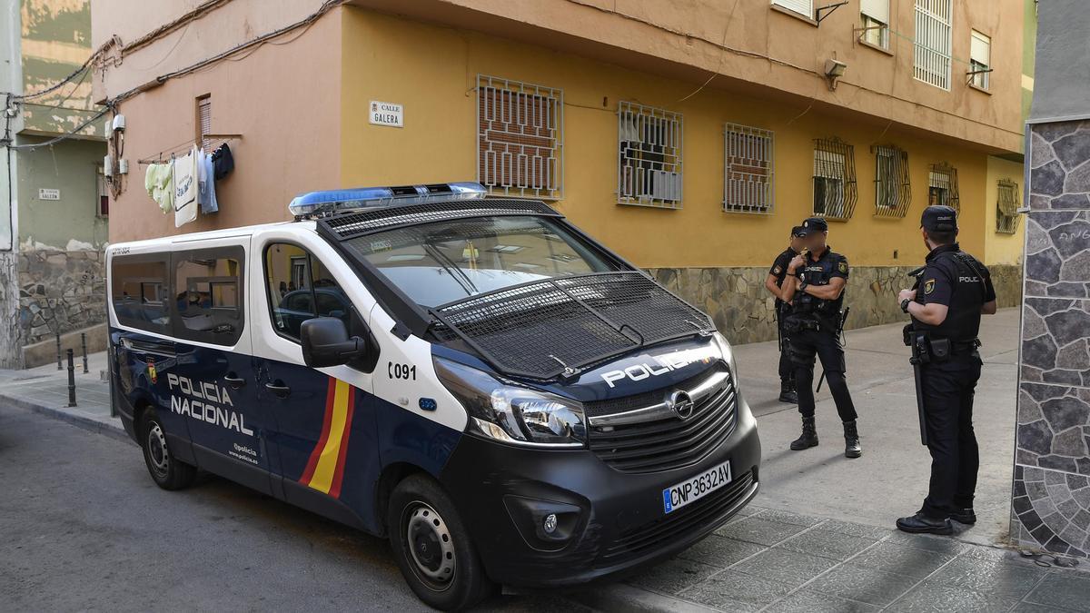 Miembros de la Policía Nacional realizan un cordón policial frente a la vivienda de una joven asesinada esta tarde en el barrio de Pescadería de Almería