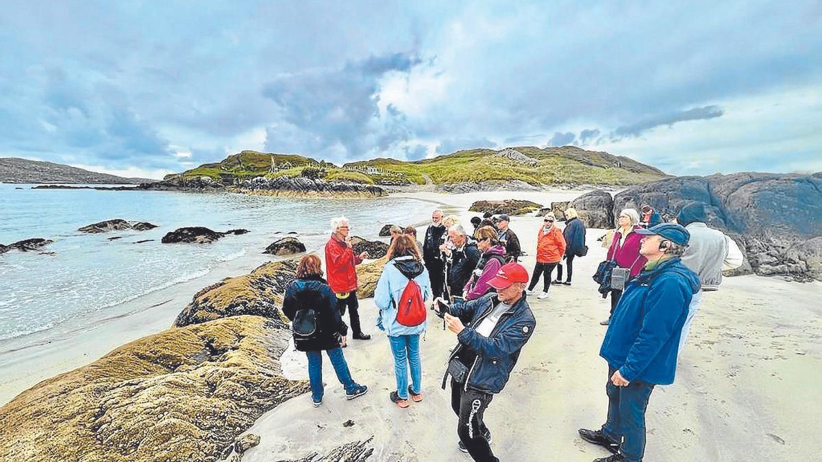 Un grupo de turistas recorre el litoral irlandés donde se recogen las algas.
