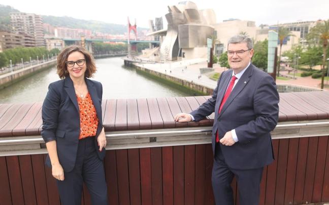 La candidata a diputada general, Elixabete Etxanobe, y el candidato a alcalde de Bilbao, Juan Mari Aburto, posan para el fotógrafo en la pasarela Pedro Arrupe, con la ría y el Museo Guggenheim como marco incomparable.