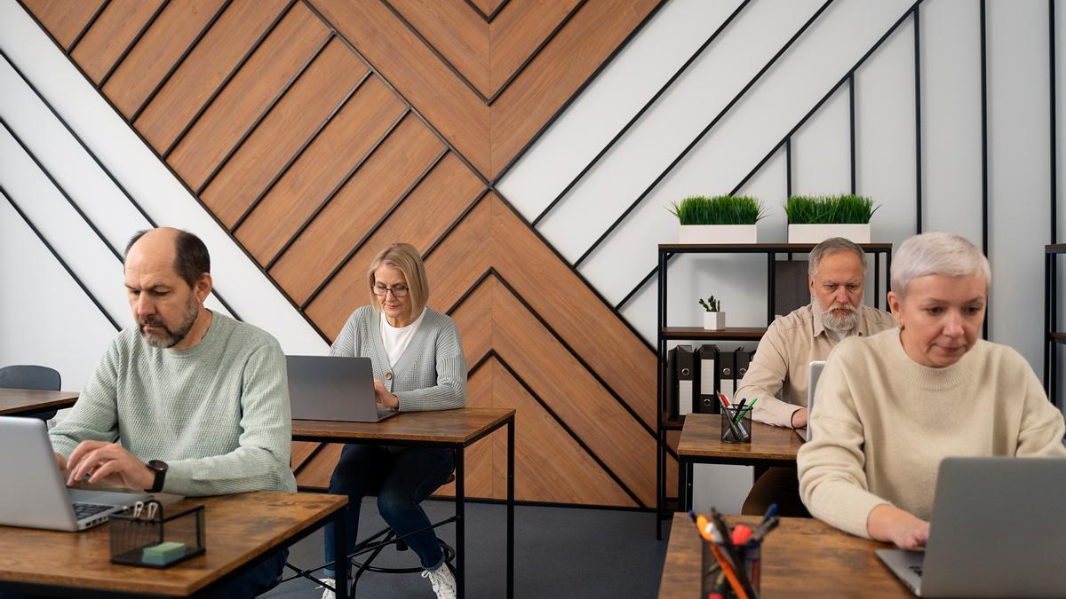 Un grupo de personas mayores participa en un curso de informática.