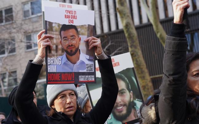 A woman holds a poster with the image of Ran Gvili, an Israeli hostage, during a rally demanding for the release of Israeli hostages kidnapped by Hamas at Dag Hammarskjold Plaza outside of the UN Headquarters. January 12th marks the 100th day of said host