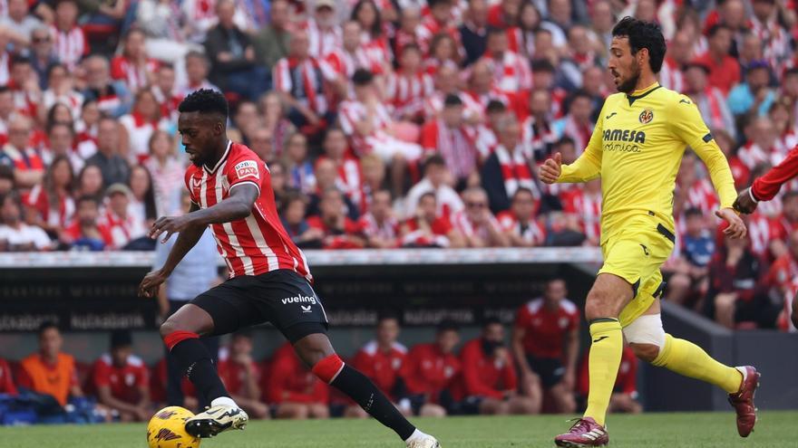 Iñaki Williams conduce un balón ante la presencia de Parejo / Athletic Club