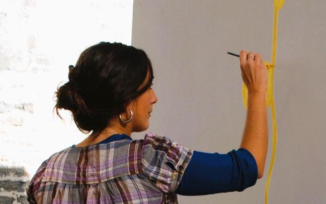 Una joven pintando en un lienzo en Amurrio / Araceli Oiarzabal Una joven pintando en un lienzo en Amurrio