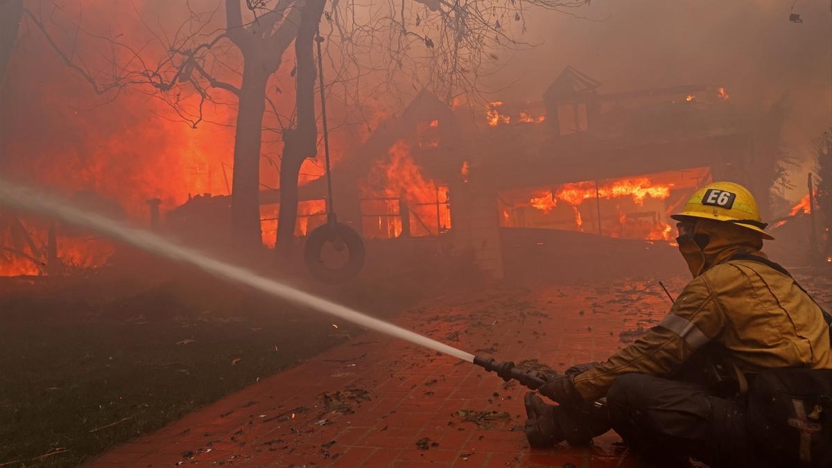 Dotaciones de bomberos trabajan en sofocar las llamas que están arrasando Los Ángeles.