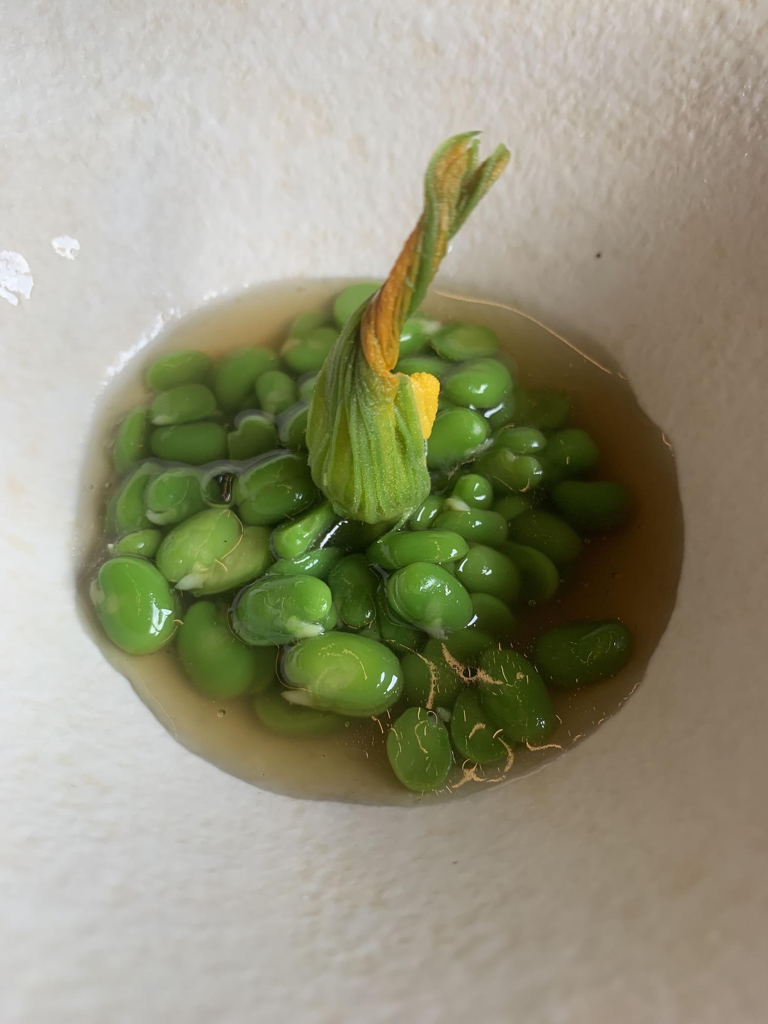 Habitas repeladas con caldo de hongos y flor de calabacín, del Txispa.
