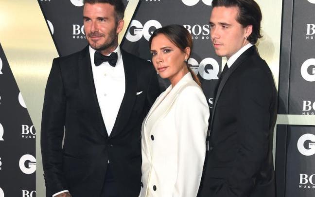 David, Victoria y Brooklyn Beckham.