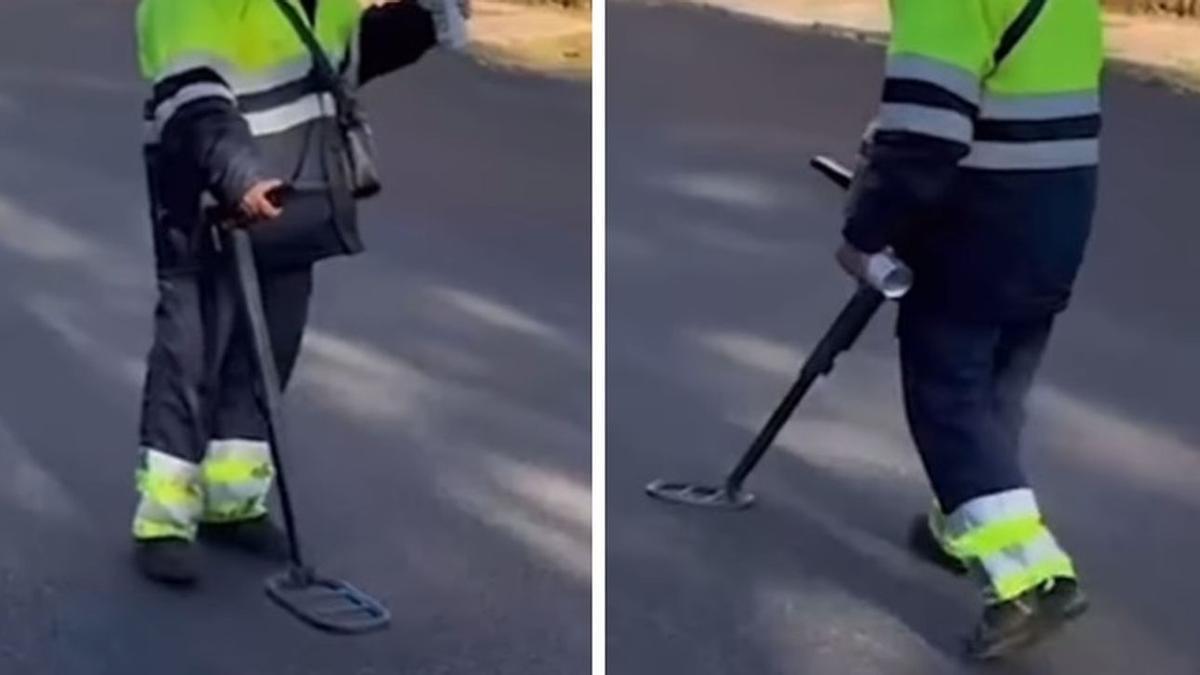 Un trabajador busca las alcantarillas con un detector de metales.