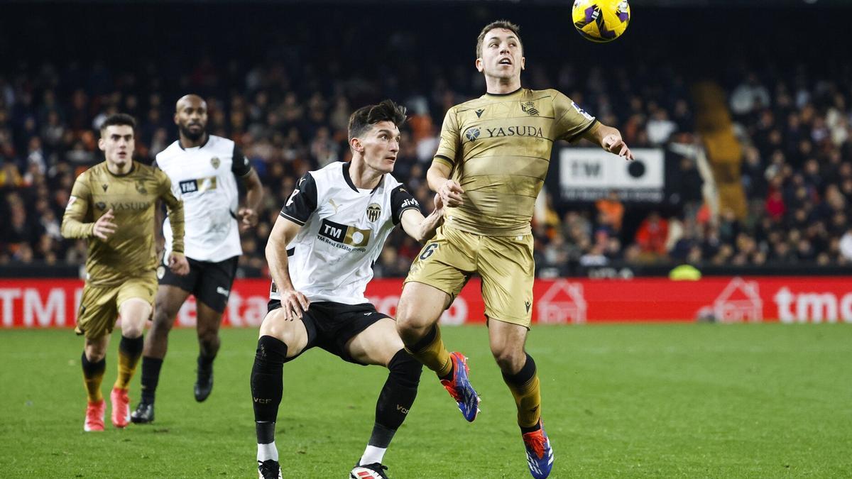 Olasagasti intenta controlar un balón aéreo ante la presión de Pepelu, en el partido disputado ayer en Mestalla. EFE / ANA ESCOBAR