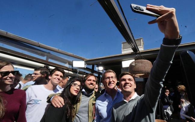 Feijóo posa para una foto con jóvenes en un acto de vivienda en Madrid.