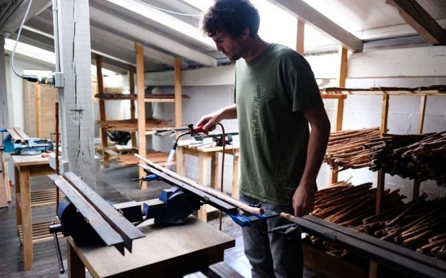 Beñat Alberdi en el proceso de enderezado de las ramas de níspero salvaje con las que fabrica artesanalmente las makilas.