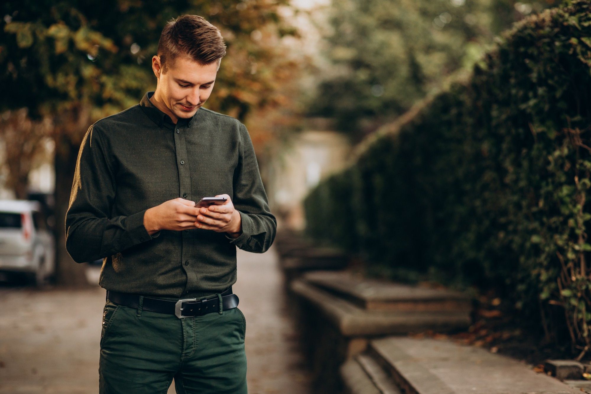 A man writes a message on WhatsApp on his mobile phone.