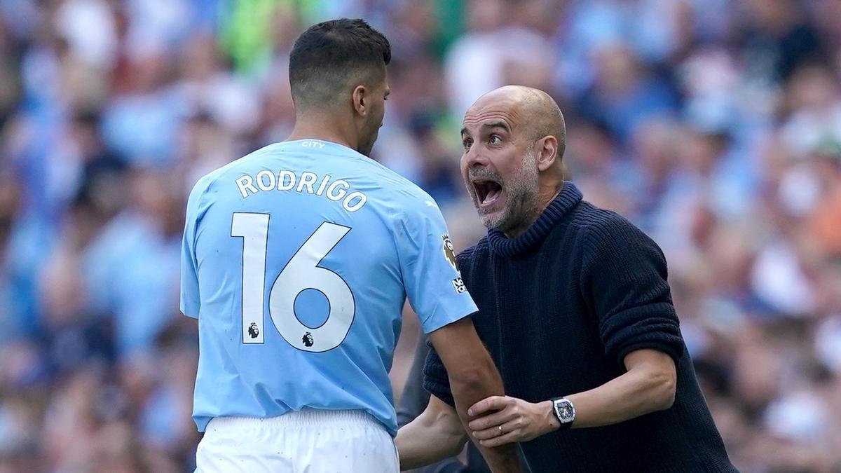 Pep Guardiola da instrucciones a Rodri durante un partido del Manchester City.