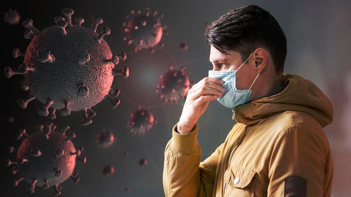 Un hombre con mascarilla junto a una representación de un virus.