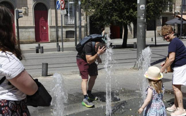 Varias personas se refrescan en una fuente durante una ola de calor en Gasteiz. Pilar Barco