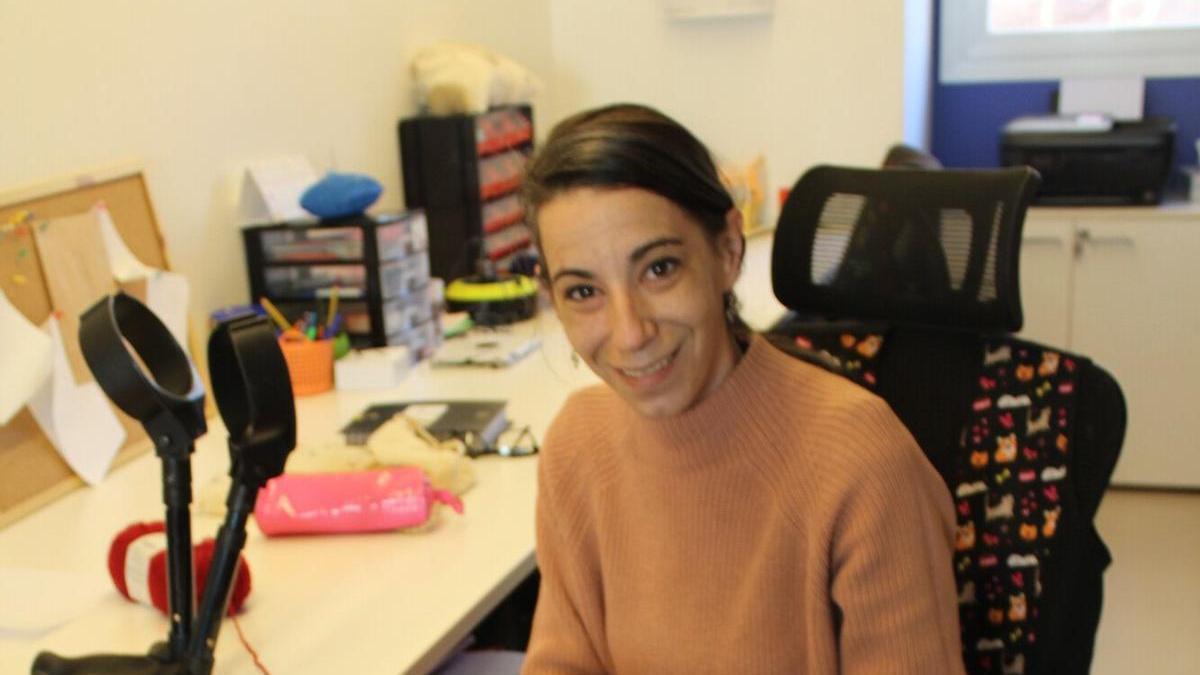 Lluna Barquero, en su taller ubicado en el vivero de empresas de Aoiz, ganchillo en mano entre sus prendas artesanas.