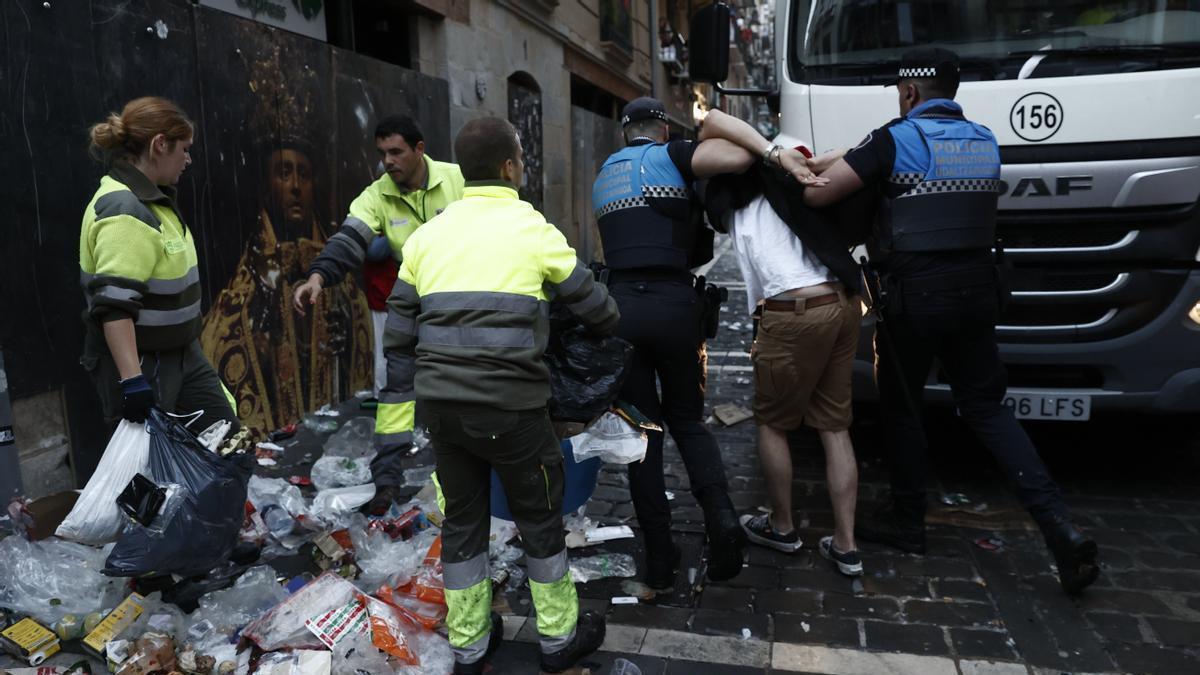 La policía municipal detiene a un hombre antes del primer encierro.