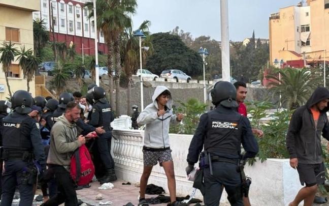 Inmigrantes durante el traslado al campamento en el Puerto de Ceuta.