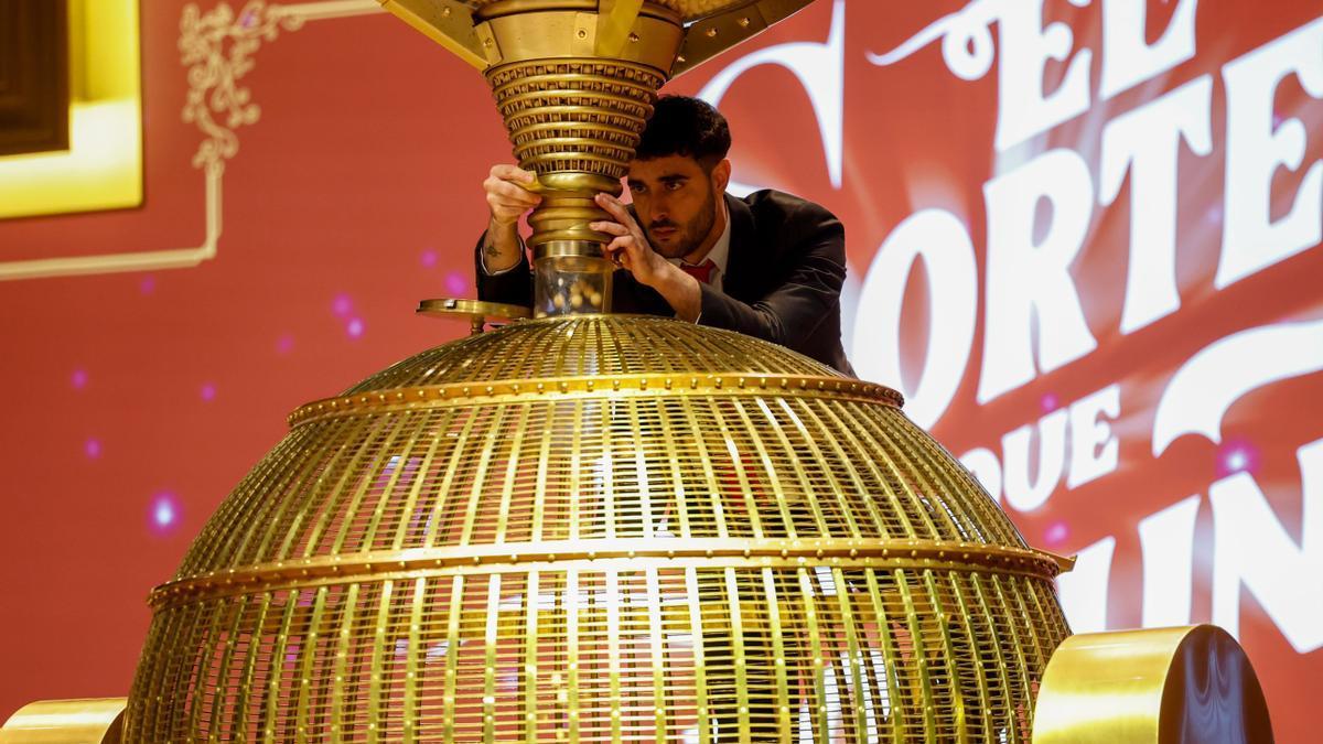 Un técnico de Loterías y Apuestas del Estado ajusta uno de los bombos del sorteo de la Lotería de Navidad.