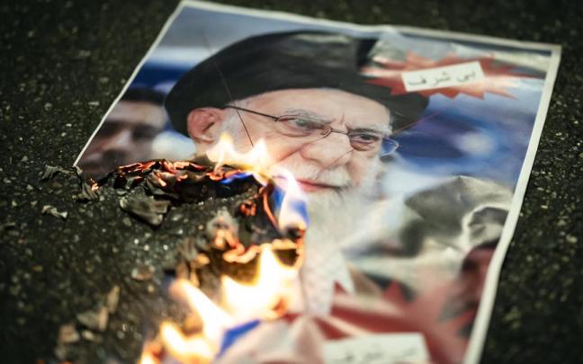 Retrato de Jamenei ardiendo durante una de las protestas en contra del régimen iraní.