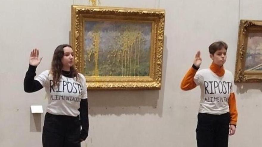 Las activistas junto al cuadro de Monet.