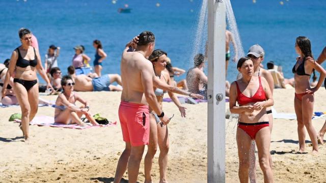 Gente refrescándose en la playa de La Concha
