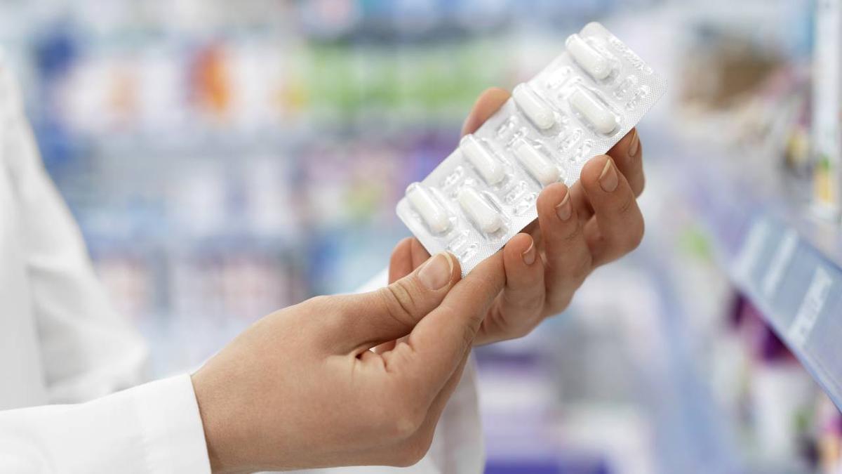 Un farmacéutico sostiene un blíster de pastillas.