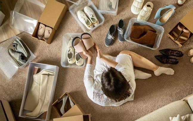 Una mujer ordena el calzado en cajas.