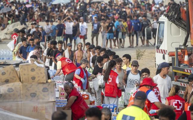 Cruz Roja reparte comida en la playa de El Trampolín, en Ceuta.