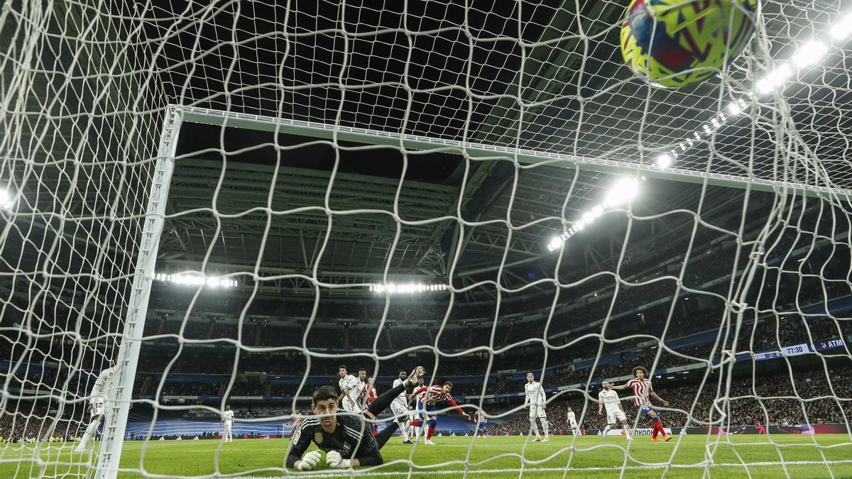 El portero del Real Madrid, Thibaut Courtois, no consigue detener el remate del defensa uruguayo del Atlético de Madrid José María Giménez