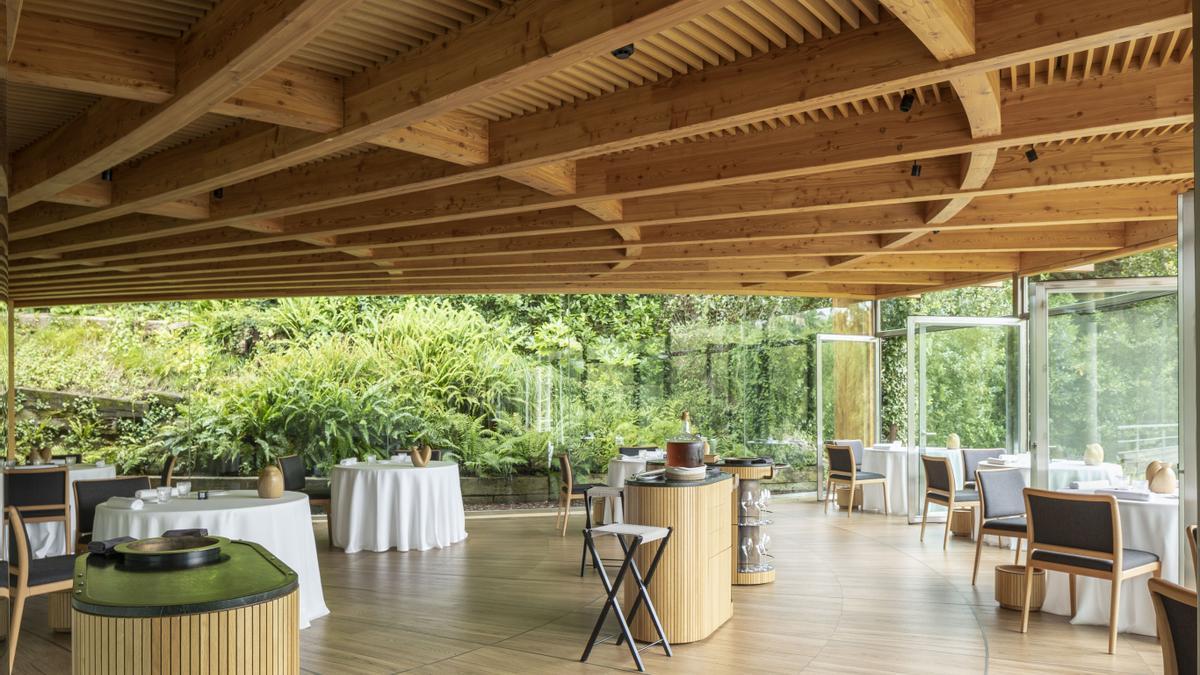 La sala del restaurante, rodeada de vegetación.
