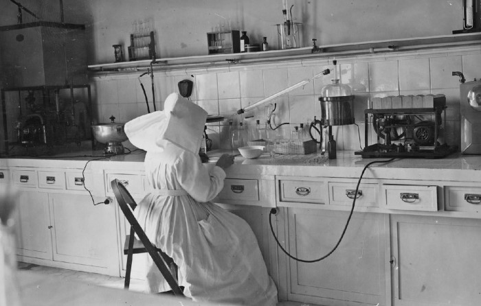 AGN, DIPUTACIÓN FORAL Y PROVINCIAL DE NAVARRA, 1936-1938. Laboratorio del Hospital de Navarra, en el centro, una religiosa de las Hermanas de la Caridad de San Vicente de Paúl con hábito sentada ante una mesa de trabajo. Sobre la mesa, recipientes de vidrio y cerámica y diverso instrumental de investigación médica. AGN, DIPUTACIÓN FORAL Y PROVINCIAL DE NAVARRA, 1936-1938. Laboratorio del Hospital de Navarra, en el centro, una religiosa de las Hermanas de la Caridad de San Vicente de Paúl con hábito sentada ante una mesa de trabajo. Sobre la mesa, recipientes de vidrio y cerámica y diverso instrumental de investigación médica.