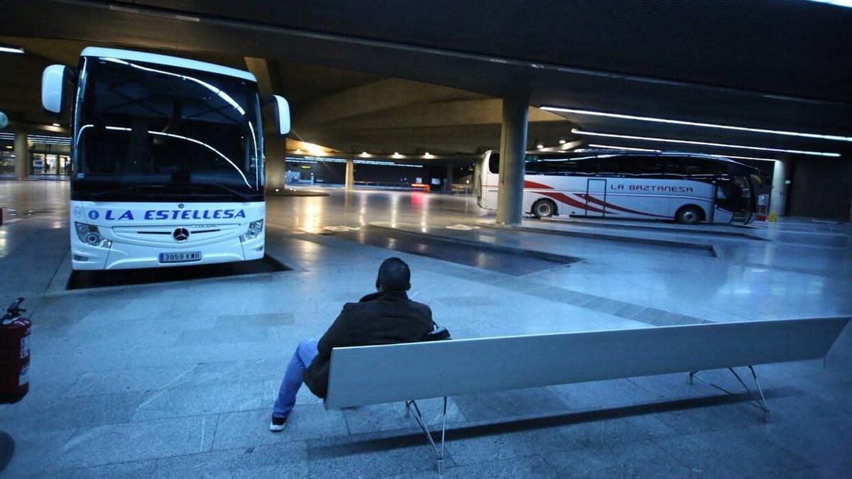 Una persona espera un autobús en el interior de la estación de Pamplona.