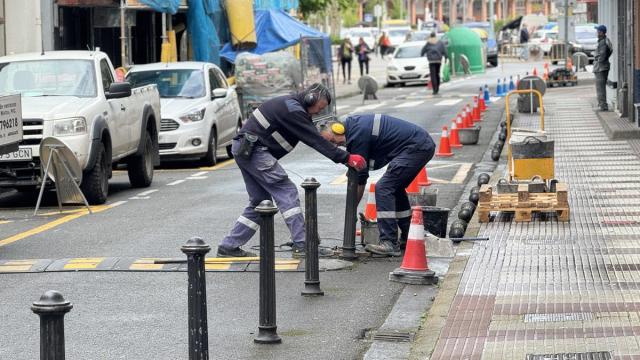 Operarios retirando este martes los pivotes de la calle Zarugalde.