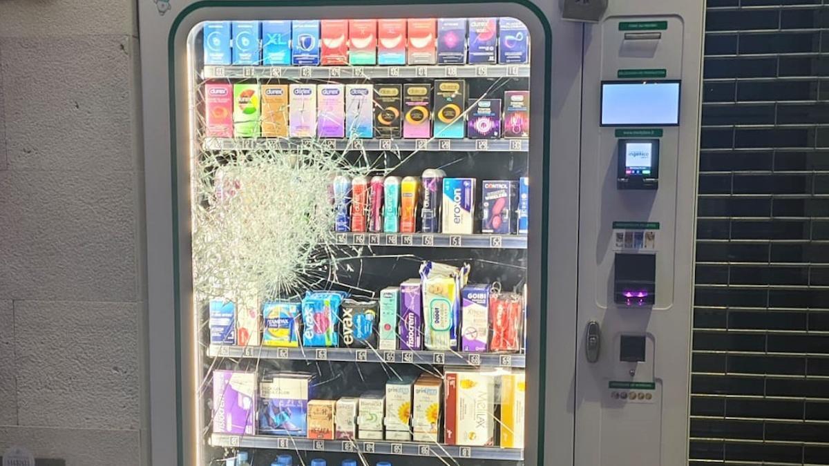Máquina expendedora de una farmacia con el cristal roto.