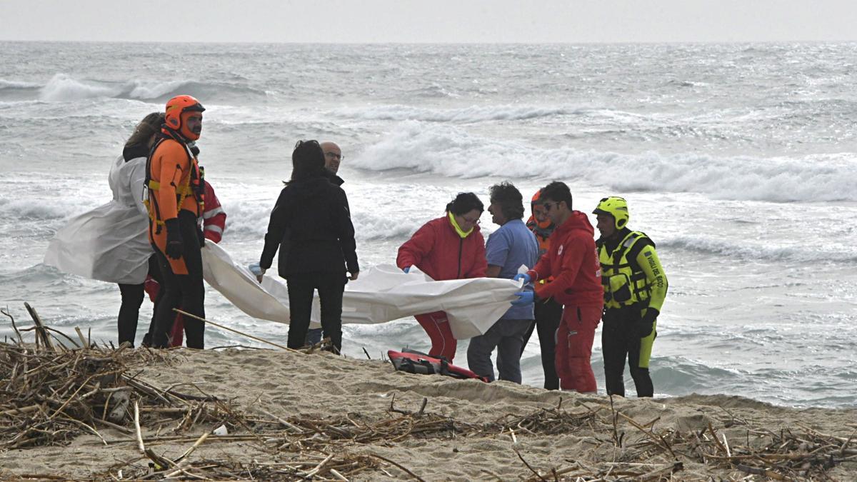 Los equipos de rescate trasladan el cuerpo de una de las víctimas del naufragio.