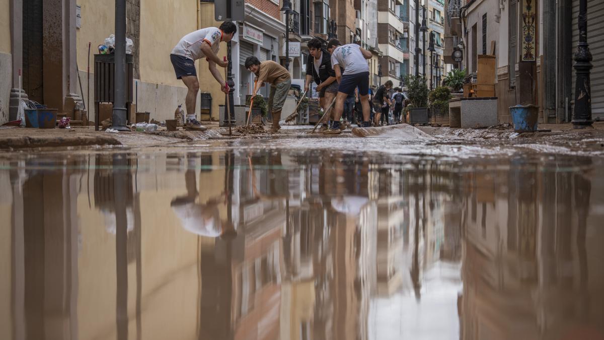 Varias personas colaboran en las labores de limpieza en Aldaia, Valencia