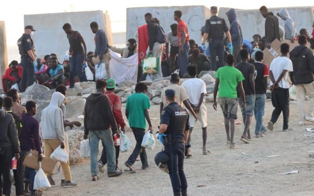 En imágenes | Traslado de los migrantes de la playa del Trampolín