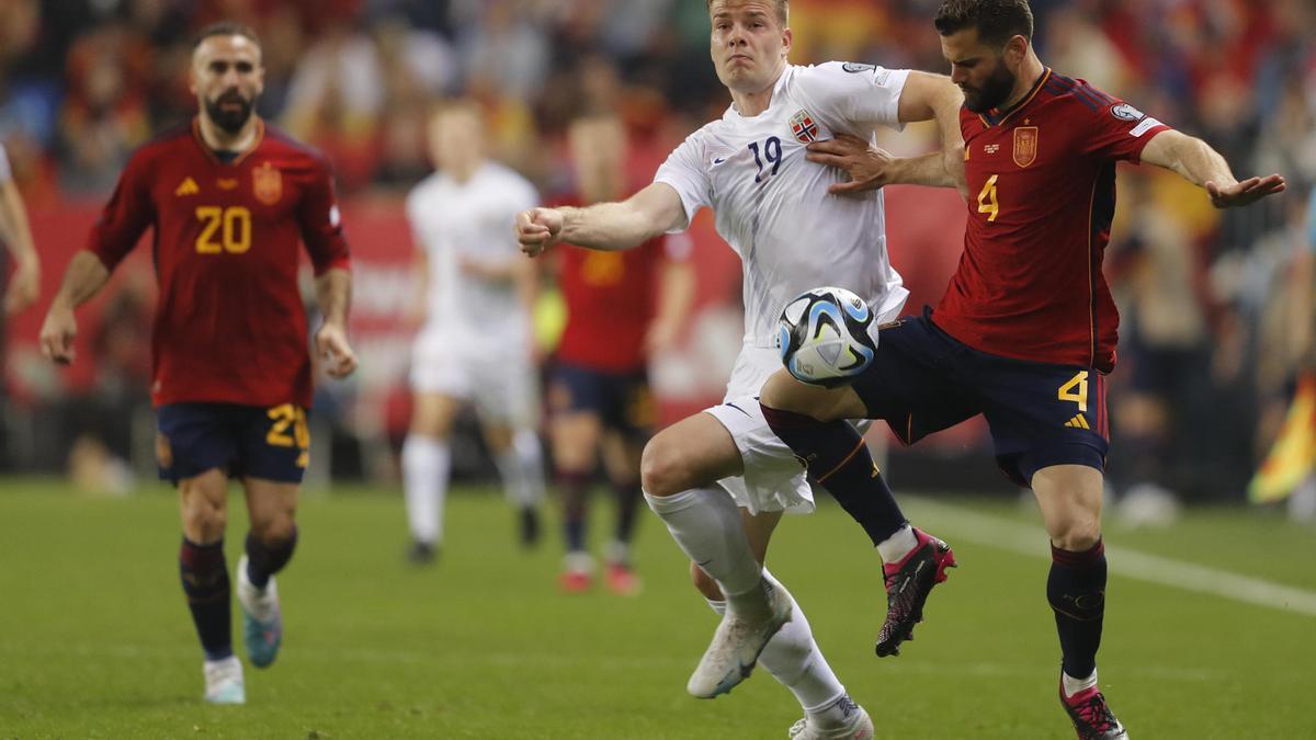 El defensa de la selección española de fútbol Nacho (d) pelea un balón con el delantero noruego Alexander Sørloth