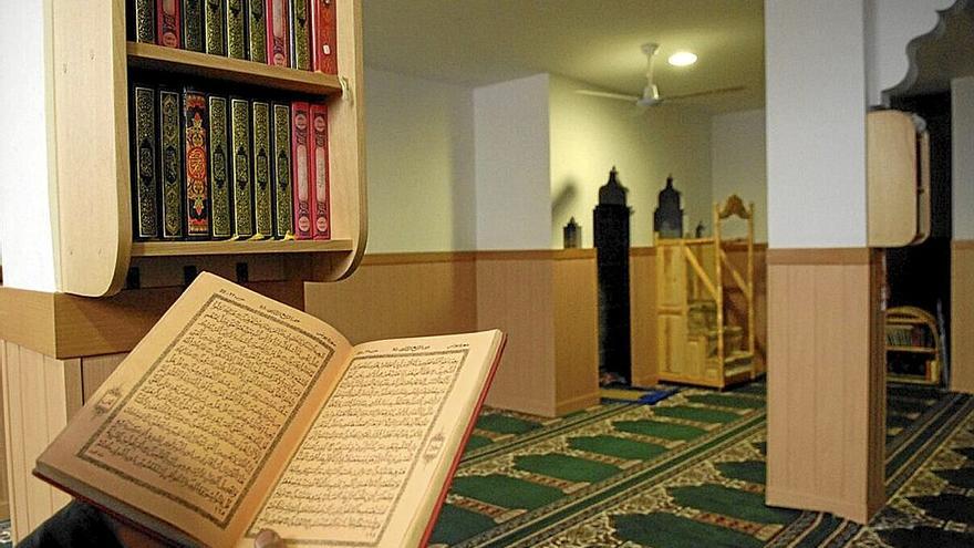 Muslim reading the Qur'an in a mosque.