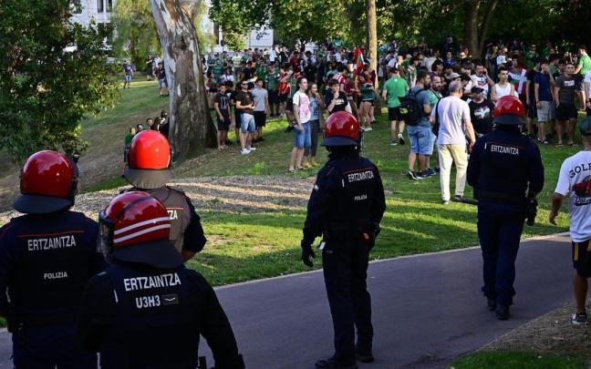 Agentes de la Ertzaintza frente a un grupo de personas durante los altercados registrados en Bilbao el día de la Final del Mundial de Fútbol entre Argentina y España