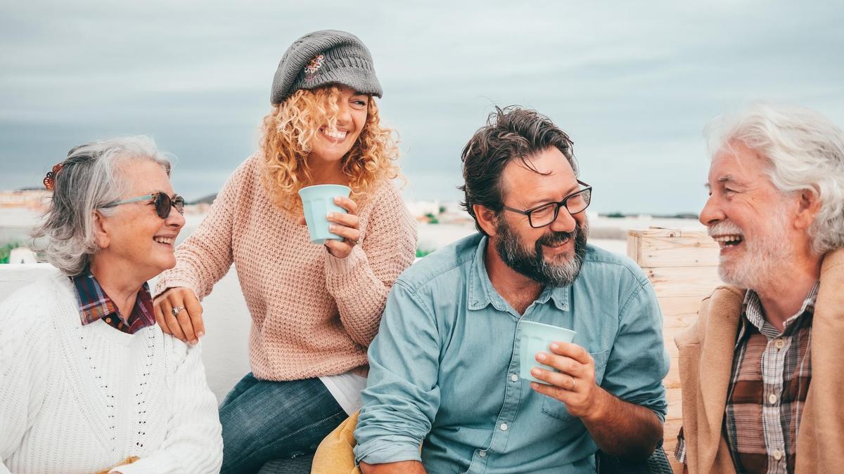 Cuatro amigos disfrutan de un buen momento en una terraza.