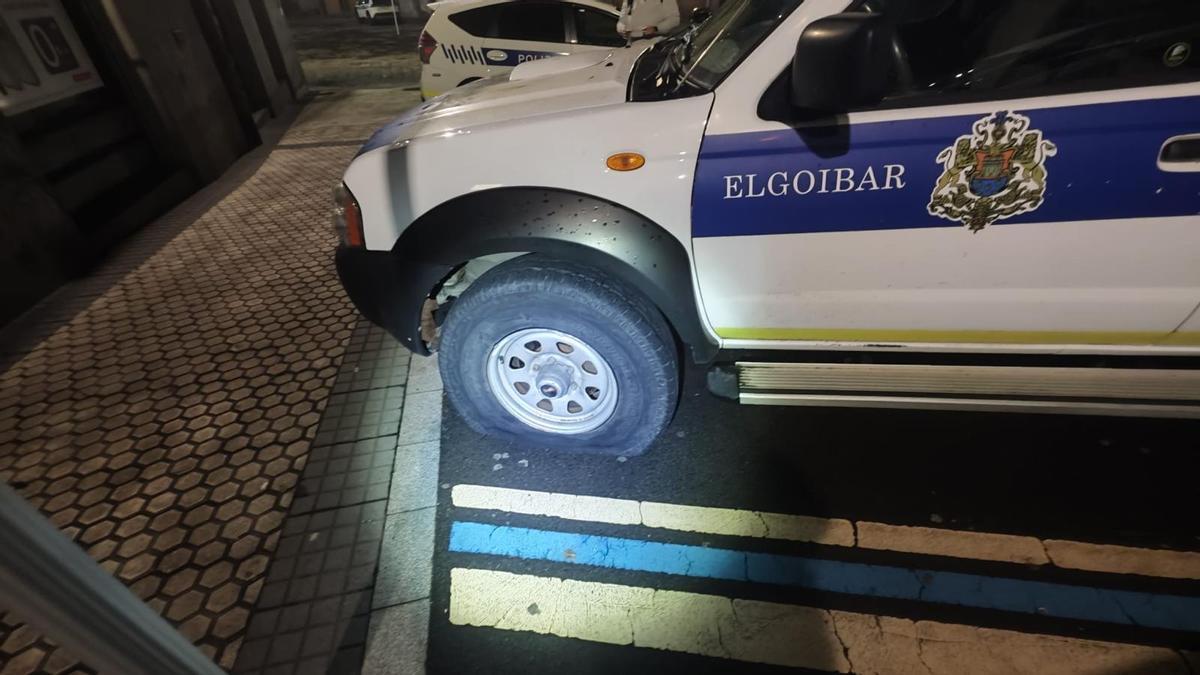 Uno de los vehículos de la Policía Municipal, con la rueda pinchada.