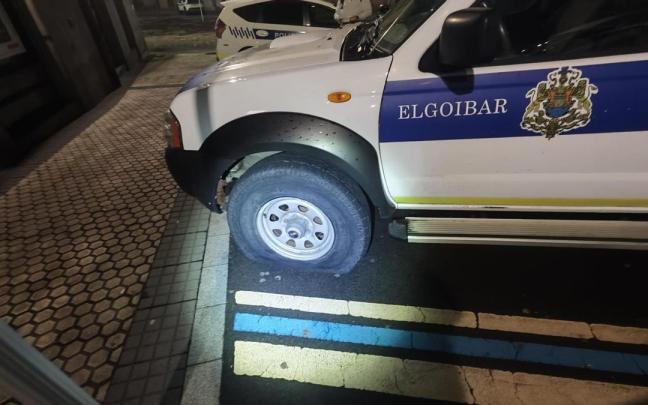Uno de los vehículos de la Policía Municipal, con la rueda pinchada.